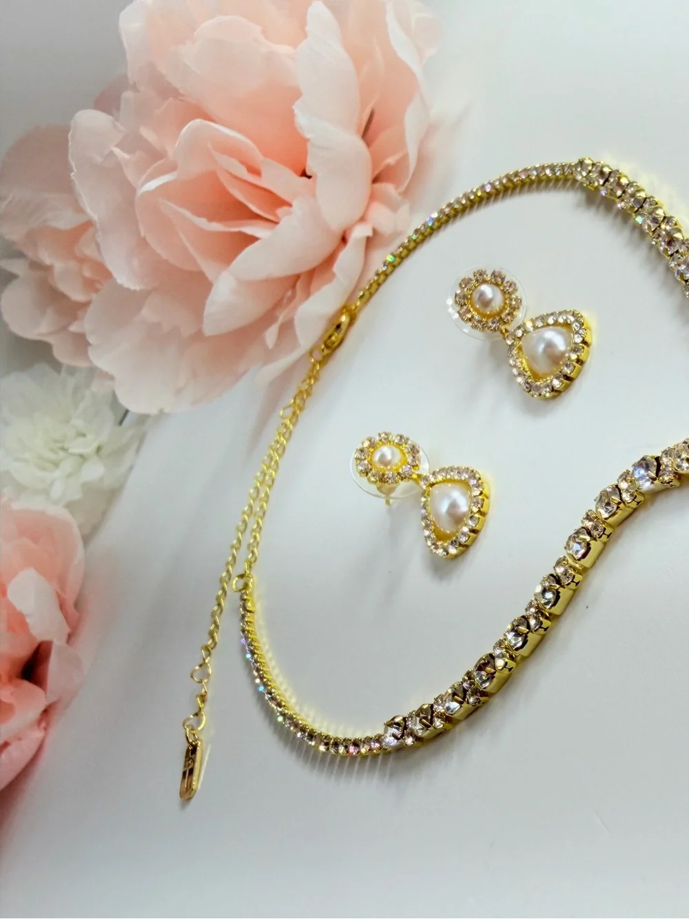 Elegant gold-tone necklace with earrings featuring a white teardrop pearl pendan